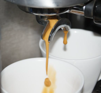 Espresso machine pouring coffee into mug